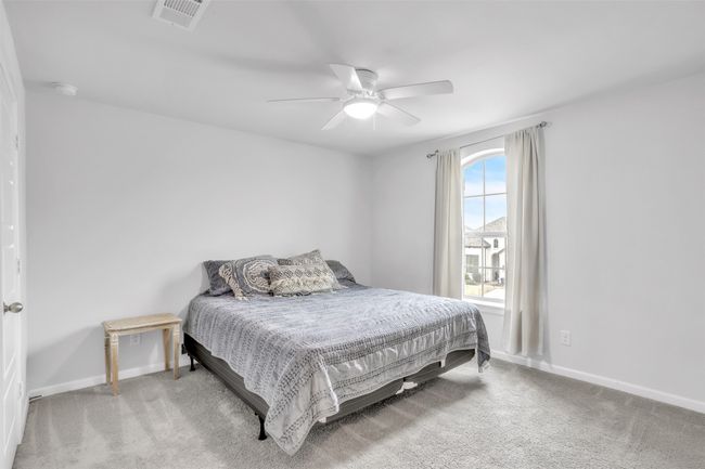 Carpeted bedroom featuring ceiling fan | Image 28