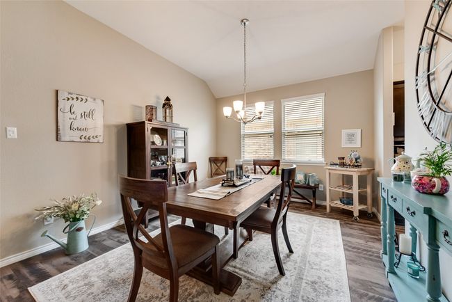 Dining area featuring a chandelier, lofted ceiling, and wood finished floors | Image 7