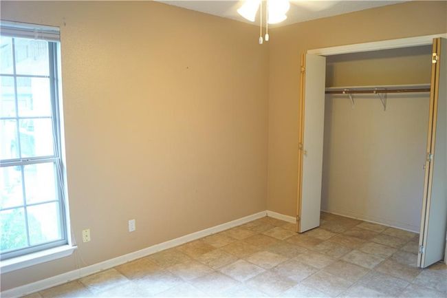 Unfurnished bedroom with multiple windows and a closet | Image 11