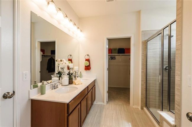 Full bath with double vanity, a spacious closet, and a stall shower | Image 19
