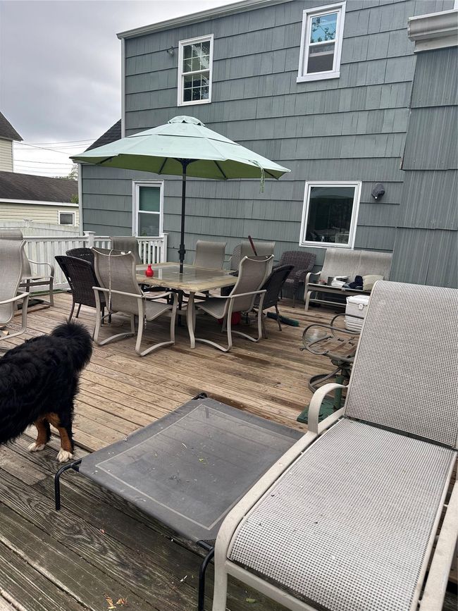 Wooden terrace featuring outdoor dining space | Image 13