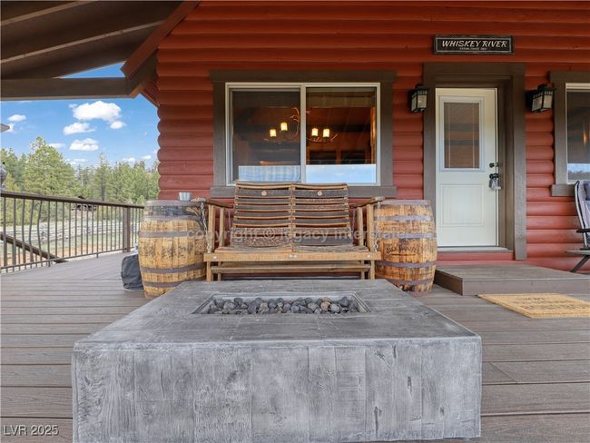 Entrance to property with a porch and faux log siding | Image 33