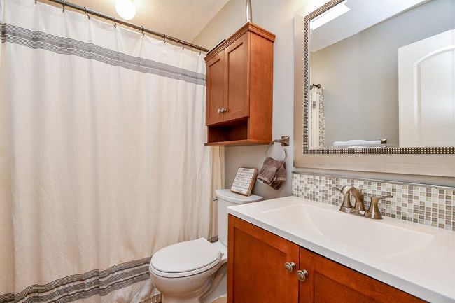 An additional bathroom features combined shower/bathtub for easy options. | Image 38