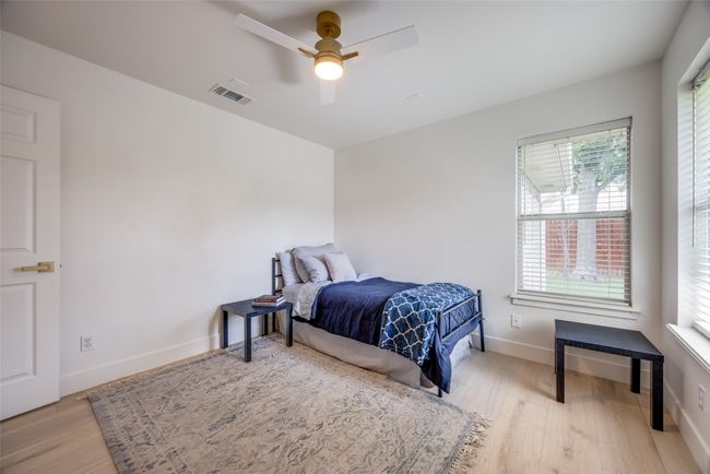 Bedroom with wood finished floors and a ceiling fan | Image 30
