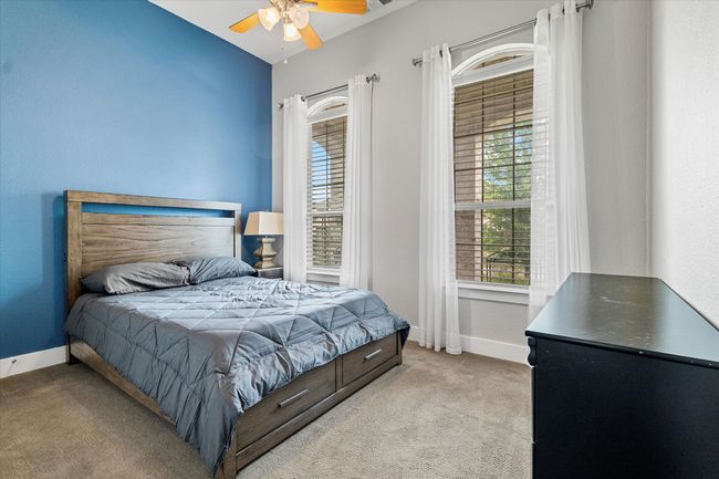 Bedroom with baseboards, a ceiling fan, and light colored carpet | Image 18