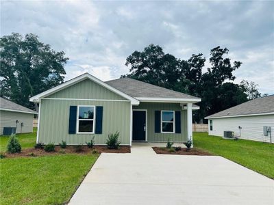 View of front of house with a front lawn and central air condition unit | Image 1