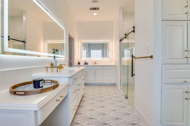 Bathroom with a sink, a shower stall, two vanities, and visible vents | Image 9