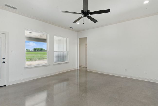 Unfurnished room featuring concrete floors, ornamental molding, recessed lighting, baseboards, and a ceiling fan | Image 10