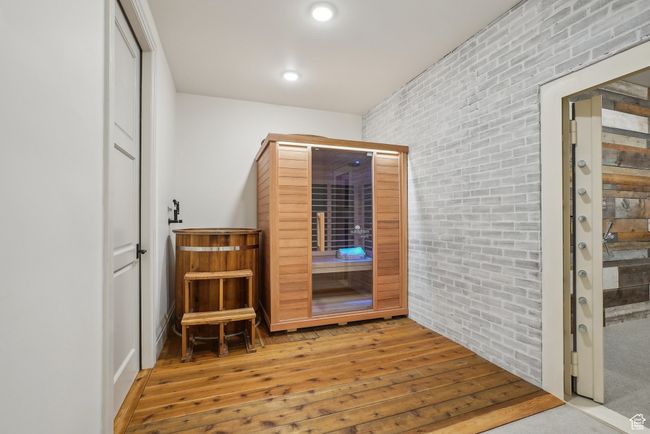 Interior space with recessed lighting, brick wall, and wood finished floors | Image 43