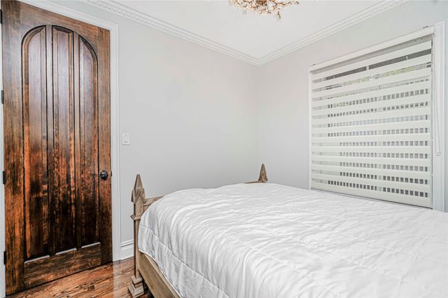 Bedroom featuring ornamental molding and wood finished floors | Image 24