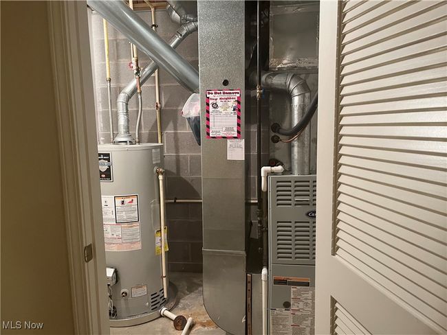 Hot Water Tank (2017) and Furnace in their hown room, hidden behind a door in the Basement. | Image 27