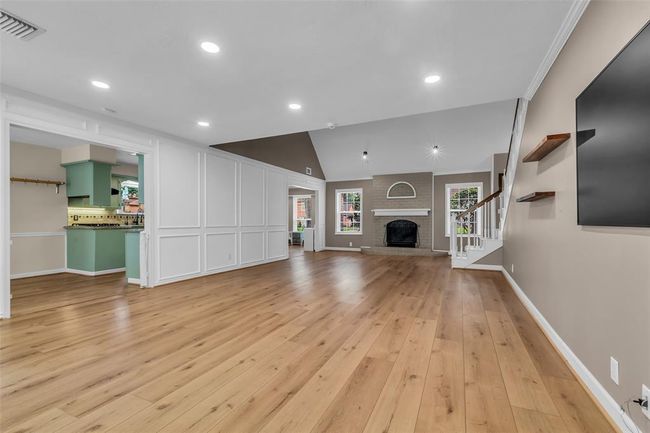 The living room offers direct access to the breakfast room and kitchen. | Image 13