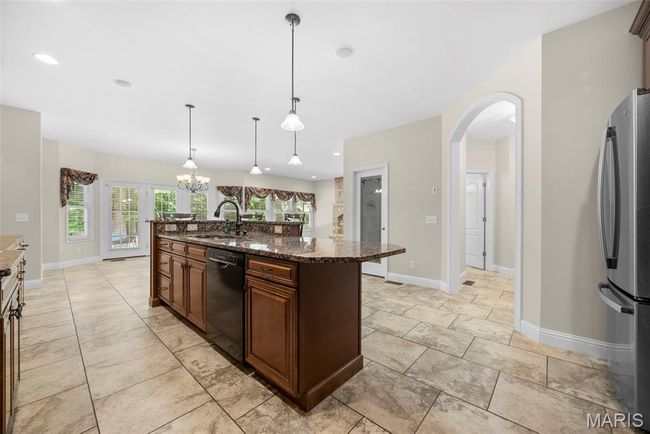 Spacious Kitchen with custom cabinetry and center island with breakfast bar. | Image 10