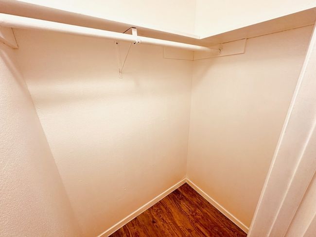 Walk in closet featuring dark wood-style flooring | Image 8