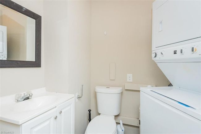 Laundry with 1/2 bath & Stackable washer & dryer to remain | Image 18