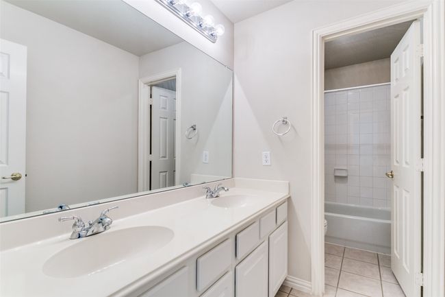 Full bath upstairs with dual sinks and tub-shower combo. | Image 23
