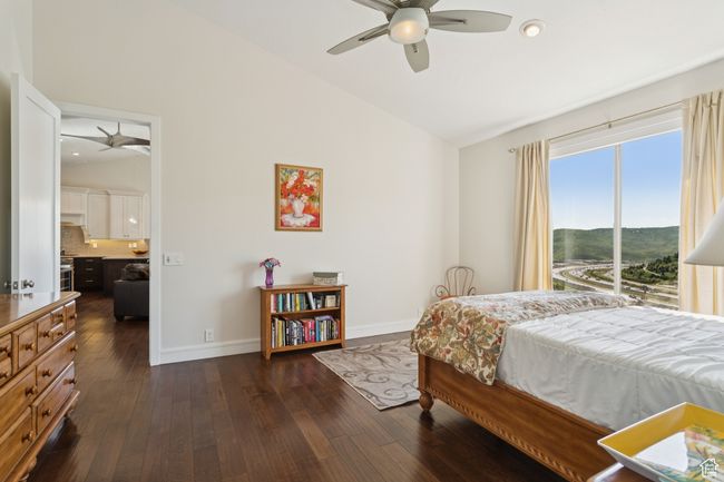 Bedroom featuring dark wood-type flooring, high vaulted ceiling, and ceiling fan | Image 17