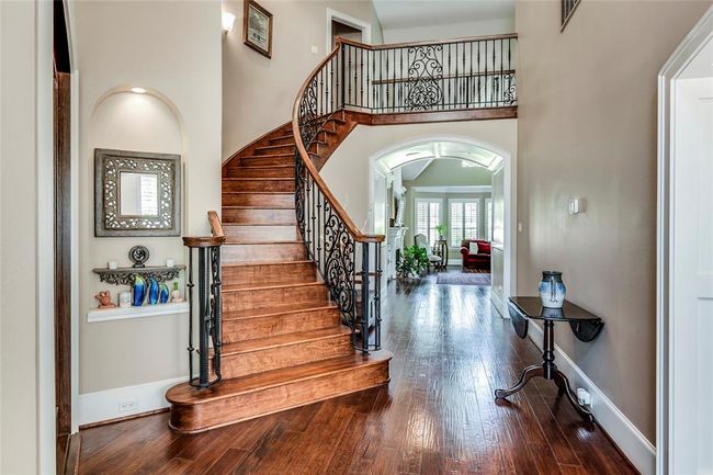 Stunning wrought iron stair case with hardwood steps, art niche | Image 8