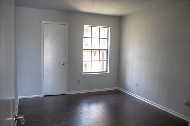 Unfurnished room featuring baseboards, dark wood-type flooring, and a healthy amount of sunlight | Image 16