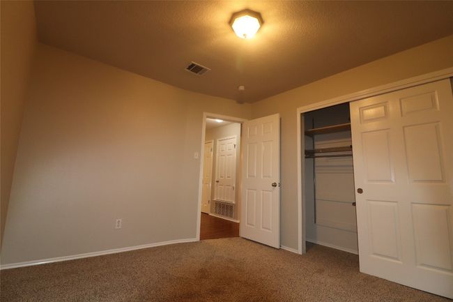 Unfurnished bedroom with carpet flooring and a closet | Image 10