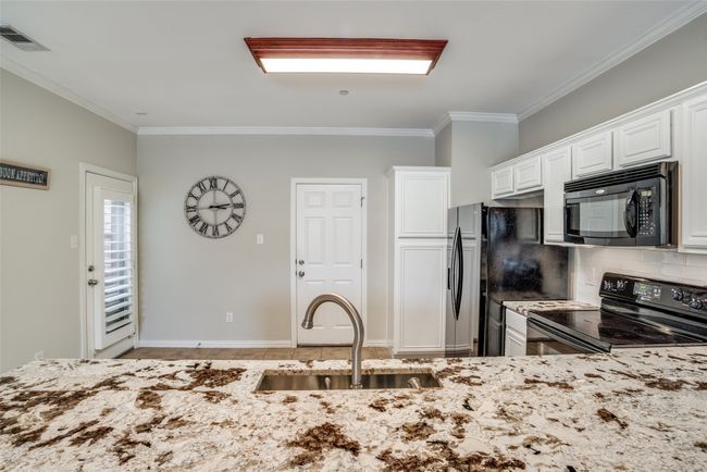 Gorgeous granite showcased by white cabinets | Image 7