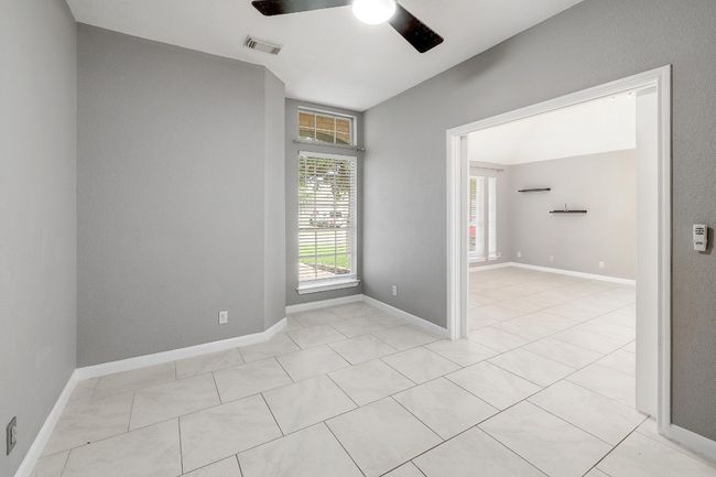 Unfurnished room with light tile patterned flooring, ceiling fan, baseboards, and visible vents | Image 26