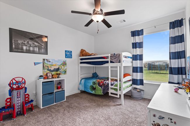 Bedroom with a ceiling fan, visible vents, and carpet flooring | Image 28