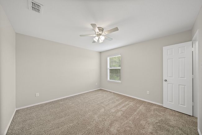 Empty room featuring ceiling fan and carpet | Image 35