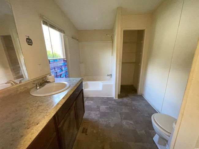 Full bathroom with toilet, vanity, and bathtub / shower combination | Image 17