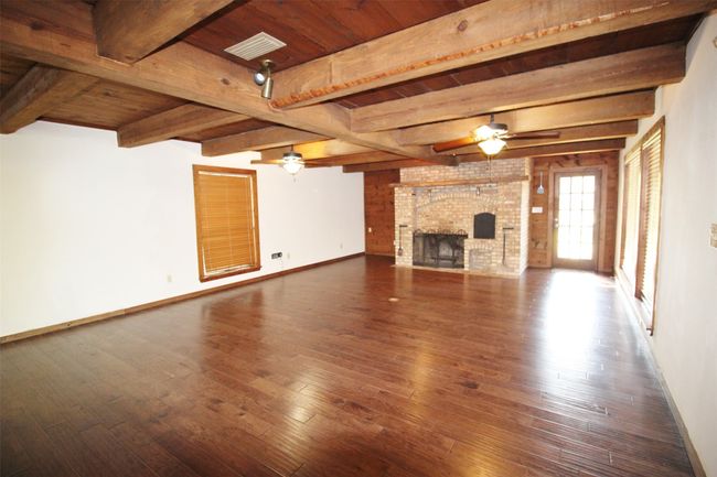Wood burning fireplace. Entry to covered patio and storage room | Image 5