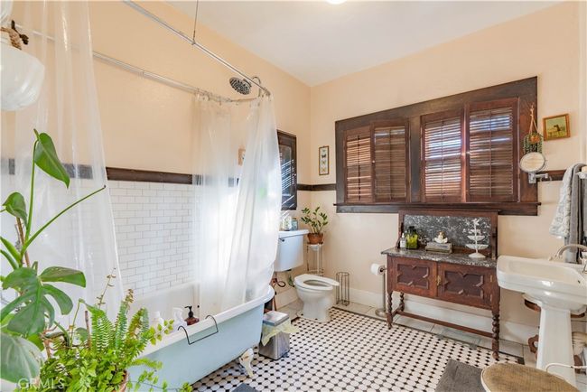 Soaking tub, updated vanity, and Craftsman finishes blend vintage charm with modern comfort. | Image 32