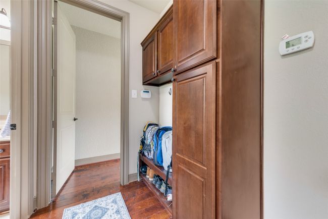 Mudroom with dark wood-style flooring and baseboards | Image 22