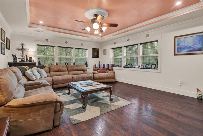 Another view of the living area. The windows windows bring in natural light while the wide window ledge can be used to show your favorite photos. Note the beautiful floors throughout the area as well. | Image 9