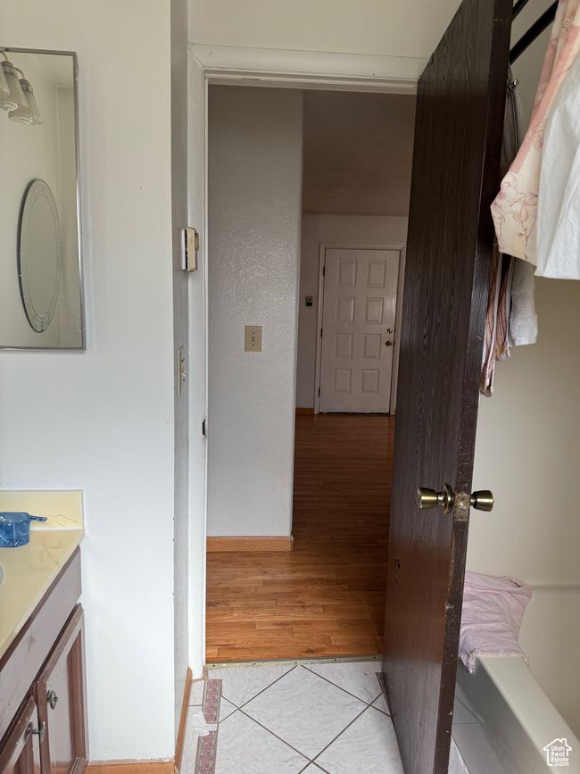 Corridor featuring light tile patterned flooring and baseboards | Image 13