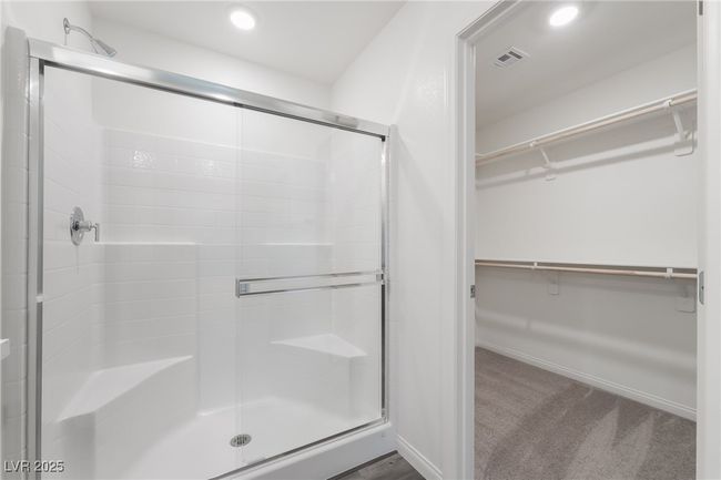 Bathroom with a walk in closet, a shower stall, and recessed lighting | Image 22
