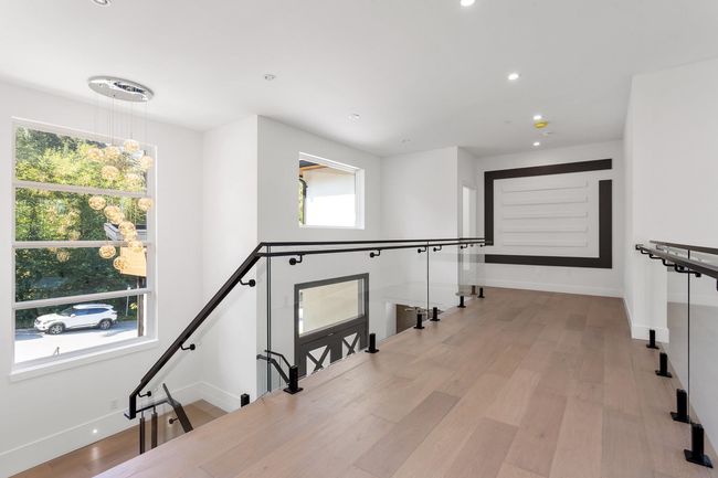 Hallway with recessed lighting, light wood-type flooring, an upstairs landing, and baseboards | Image 27