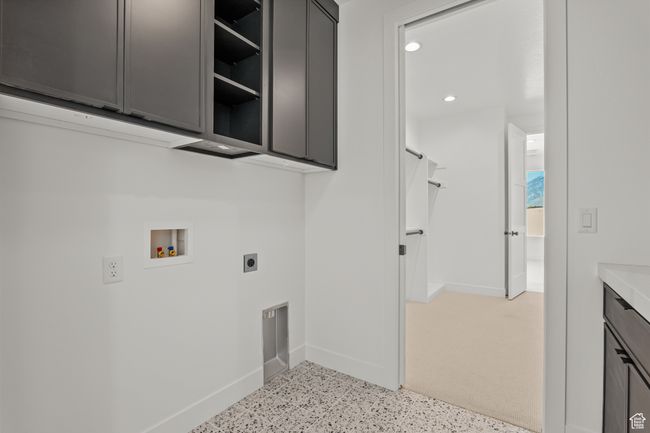 Laundry room with cabinet space, hookup for a washing machine, recessed lighting, and electric dryer hookup | Image 49