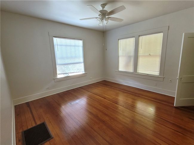 Bedrooms feature hardwood floor and natural light | Image 14