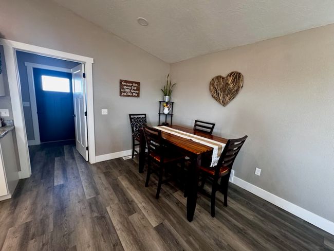 Dining area featuring baseboards, dark wood finished floors, and vaulted ceiling | Image 18