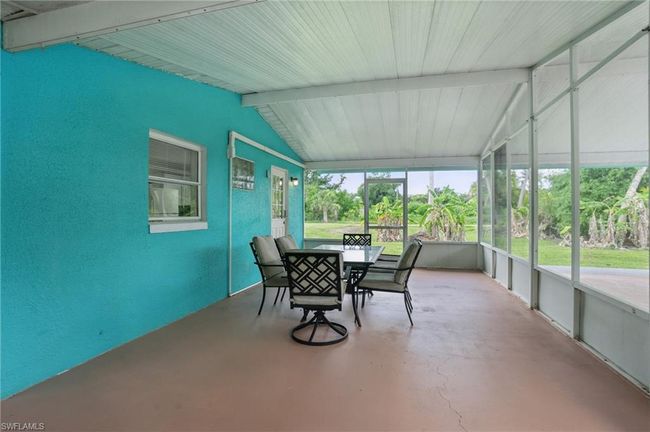Sunroom / solarium featuring outdoor dining space | Image 11