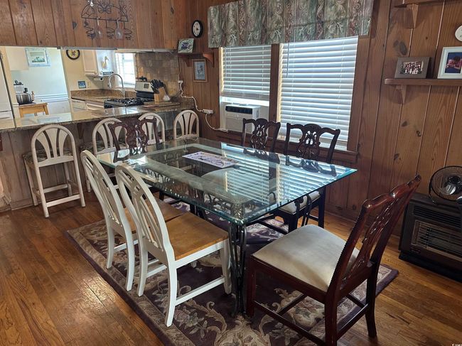 Dining space with wood finished floors and wooden walls | Image 11