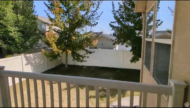 View of yard with fence and a balcony | Image 84