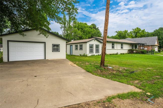 Single story home featuring a garage and a front yard | Image 5