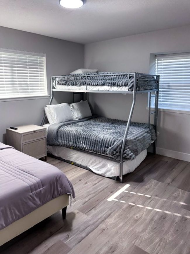 Bedroom featuring hardwood / wood-style flooring and multiple windows | Image 9