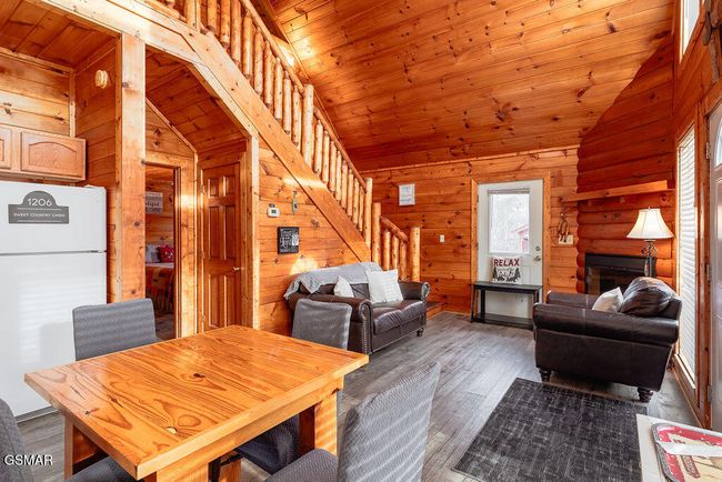 Cabin 1 Kitchen/Living Room Electric Fireplace in the corner. | Image 8