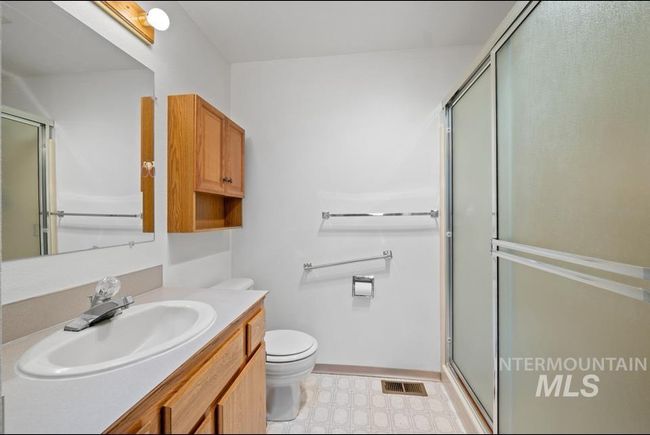 Full bath featuring tile patterned floors, vanity, and an enclosed shower | Image 12