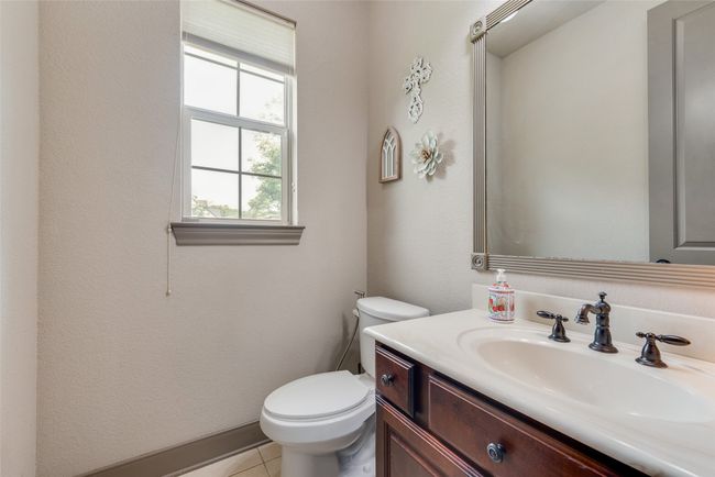 Half bathroom with vanity and tile patterned flooring | Image 24