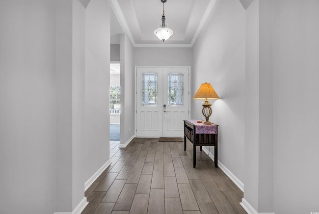 Foyer featuring baseboards, wood tiled floor, and crown molding | Image 13