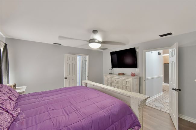 Bedroom with light wood-type flooring and ceiling fan | Image 21