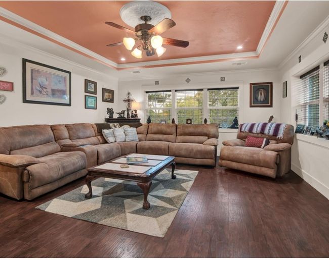 Craftsmanship is evident throughout this lovely cottage. This large living area highlights the lovely painted tray ceiling and the attention to detail in the windows and trim. | Image 7
